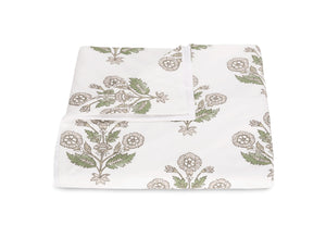 A neatly folded bedsheet from the Dalila Bedding Collection by Matouk, featuring a vibrant green and beige floral pattern inspired by Schumacher block print, displayed on a plain white background.
