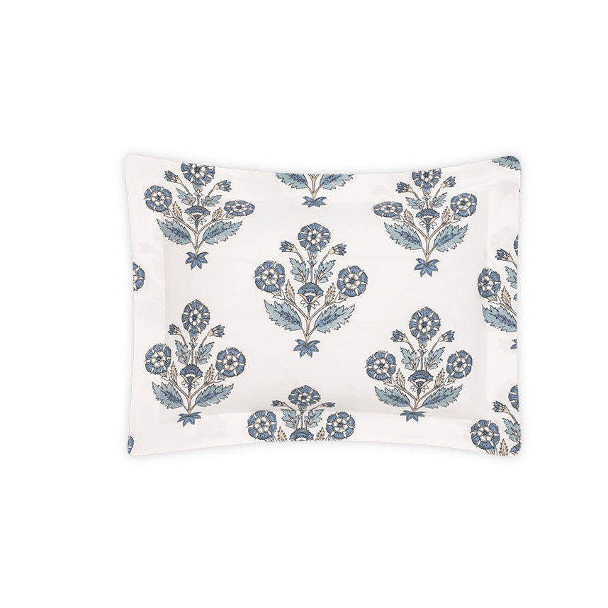 Matouk’s Dalila Bedding Collection pillowcase features a white rectangular design adorned with blue and gray floral clusters and leaves, inspired by Schumacher block prints, and is showcased on a plain white background.