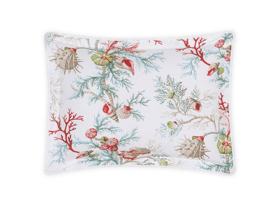 The Matouk Del Tesoro Bedding Collection Coral pillowcase is a rectangular white cover featuring colorful sea life, coral, seashells, and marine plants in red, green, and beige tones.