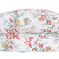 Two pillows stacked horizontally, covered with white pillowcases from the Matouk Del Tesoro Bedding Collection, showcase a vibrant sea life pattern featuring shells, coral, and seaweed inspired by deep-sea toile designs. Crafted from soft Luca percale, these pillowcases bring maritime creatures to life for a whimsical touch.