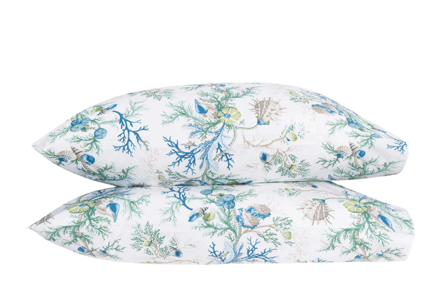 The Del Tesoro Bedding Collection by Matouk showcases two stacked pillows against a white background, adorned with an ocean-themed pattern featuring shells, seaweed, coral, and maritime creatures like starfish in soothing blue, green, and beige hues—invoking a sense of oceanic fantasy.