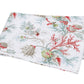The Del Tesoro Bedding Collection by Matouk features a folded white blanket adorned with a printed design of coral, seashells, maritime creatures, and marine plants in red, green, and beige tones.