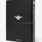 The hardcover book "Delta: 100 Years and Climbing" by Assouline celebrates Delta Air Lines’ centennial, featuring a black cover with the Delta logo and assouline.com at the bottom.
