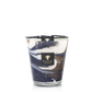 A Baobab Collection Delta Nile candle in a hand-blown glass jar with swirling blue and white design, displayed against a black background.
