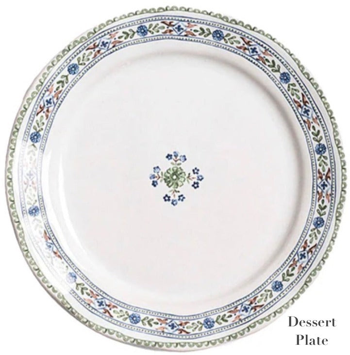 The Villa Seville Chambray Dessert Plate by Juliska features floral motifs around the rim and a central flower design—a charming addition to your dinnerware collection.