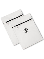 Two white L’Avant Collective Mesh Laundry Bag set micro-mesh bags with secure zipper closures and circular logos.
