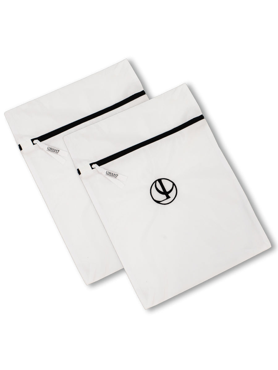 Two white L’Avant Collective Mesh Laundry Bag set micro-mesh bags with secure zipper closures and circular logos.