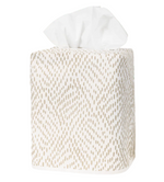 The Matouk Duma Diamond Dune Tissue Box Cover is a square cover with a beige geometric pattern, crafted from Egyptian cotton percale, and displays a few tissues emerging from the top.