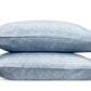 Two blue pillows from the Duma Diamond Bedding Collection by Matouk, showcasing a bold geometric pattern inspired by Schumacher design, are stacked horizontally on a white background.