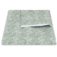 The Duma Diamond Bedding Collection by Matouk features folded patterned sheets crafted from premium Egyptian cotton percale, showcasing a striking geometric design of green, dotted diagonal lines on a white base and displayed against a white background.