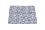 A folded fabric square from the Matouk Duma Diamond Bedding Collection, featuring a blue and white harlequin-inspired diamond motif, is displayed against a plain white background.