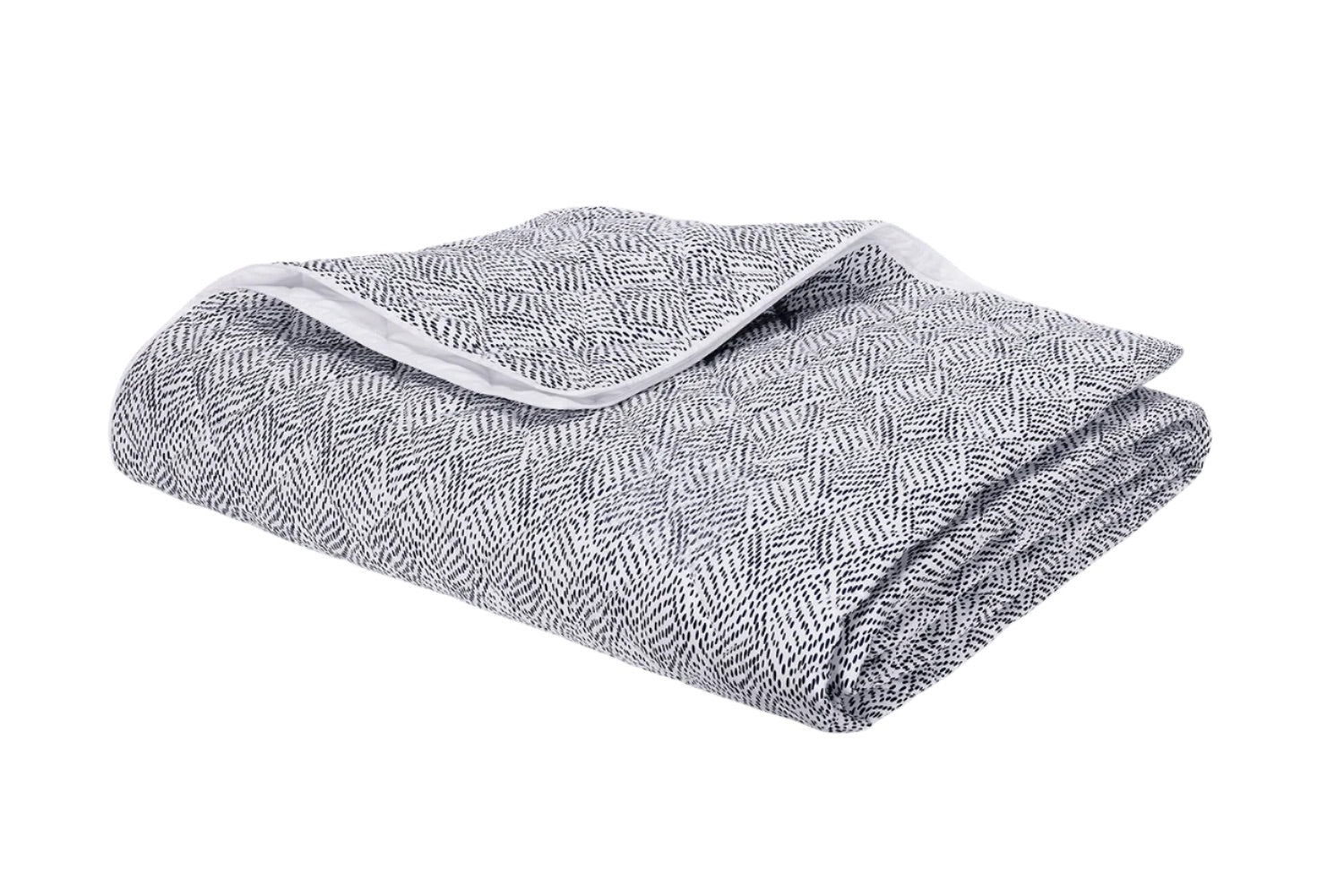 A folded gray and white blanket from the Matouk Duma Diamond Bedding Collection, featuring a subtle geometric pattern inspired by Schumacher design, displayed on a plain white background.