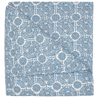 The Sahil Indigo Bedding Collection by John Robshaw features a folded blanket with an intricate blue and white floral pattern, reminiscent of Mughal garden bedding, displayed on a white background.