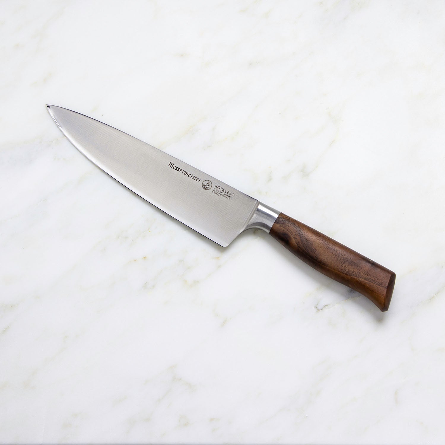 A Messermeister Royale Elite Knife Block Set, 5-Piece, featuring German stainless steel blades and wooden handles, is displayed on a white marble surface.