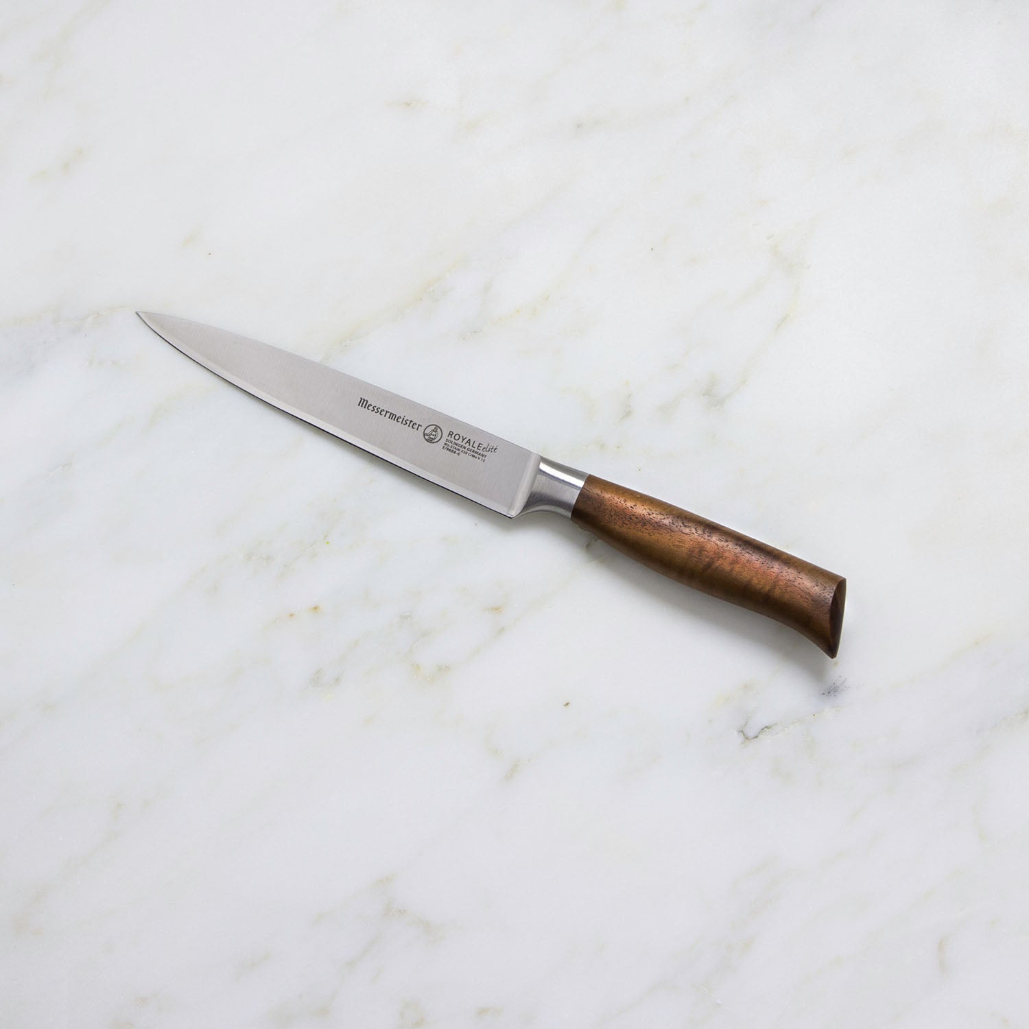 A Messermeister Royale Elite Knife Block Set, 5-Piece, with wooden handles and German stainless steel blades, is displayed on a white marble surface.