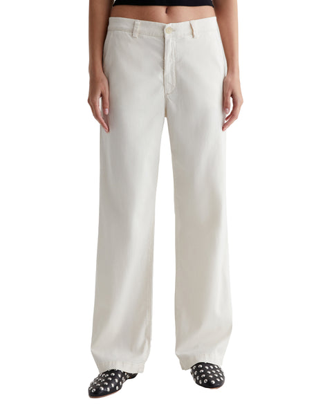 White AG Jeans Caden Straight chino pants for women on a model with patterned shoes visible.