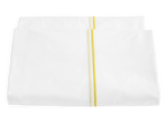 A folded white Matouk Essex Lemon Bedding Collection sheet with a yellow stripe down the center, evoking refined European hotel style, displayed on a plain background.