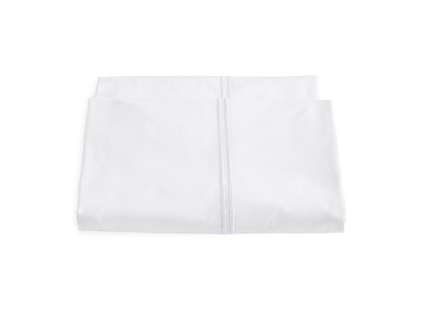 Two white pillowcase covers from the Matouk Essex Bedding Collection, made with luxurious 350 thread count fabric and satin stitch embroidery, are stacked against a white background.