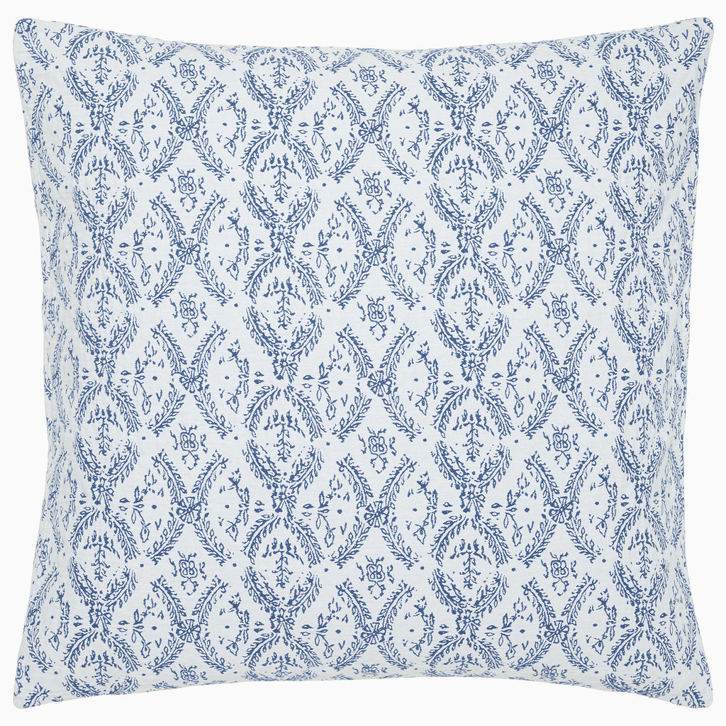 The Aashna Azure Bedding Collection by John Robshaw features a square pillow with a white background and blue floral and vine diamond tilework, inspired by Portuguese artisans, crafted from soft cotton jacquard.