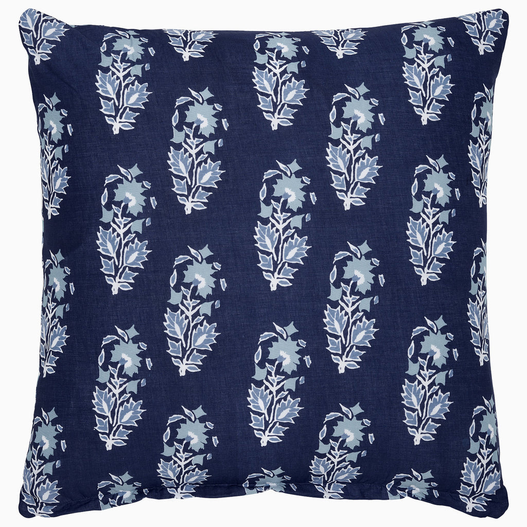 The Kanak Indigo Bedding Collection by John Robshaw features a square navy blue pillow with light blue and white leaf patterns inspired by traditional Indian block print techniques.