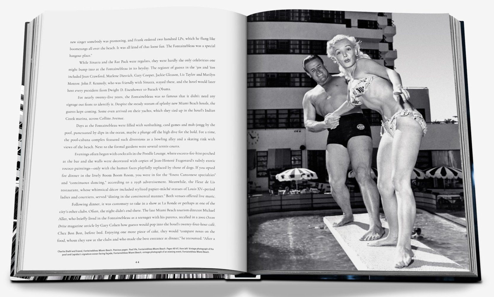 An open Fontainebleau book by Assouline shows a black-and-white photo of two people in swimwear on a diving board at the iconic hotel pool, with text on the left page capturing its architectural marvel.