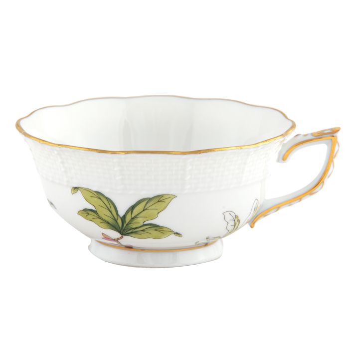 The Herend Foret Garland Collection features a white artistic porcelain teacup with gold-trimmed rim and handle, adorned with green leaf and floral designs that highlight exquisite hand-painted craftsmanship.