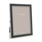 The Addison Ross Enamel and Silver Frame Collection features an elegant standing frame with a slim black enamel border, silver edges, and a versatile two-way easel, shown on a white background.