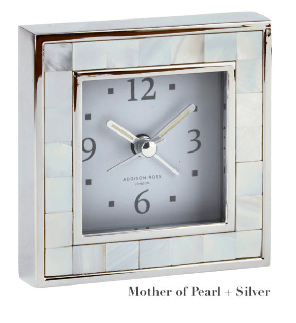 Addison Ross Square Silver Alarm Clock Collection features a mother of pearl and silver frame, black numerals and hands on a white face. "Mother of Pearl + Silver" text. Elegant addition to any nightstand.