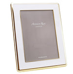 The Wide Curved Enamel Frame from Addison Ross is a rectangular white photo frame with a gold edge, a soft velvet backing, and a white mat, shown standing upright against a plain background.
