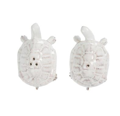 The Juliska Clever Creatures Turtle Salt and Pepper Set features two white ceramic turtles with differing shell holes, symbolizing wisdom and good luck—an ideal addition to any entertaining enthusiast’s collection.
