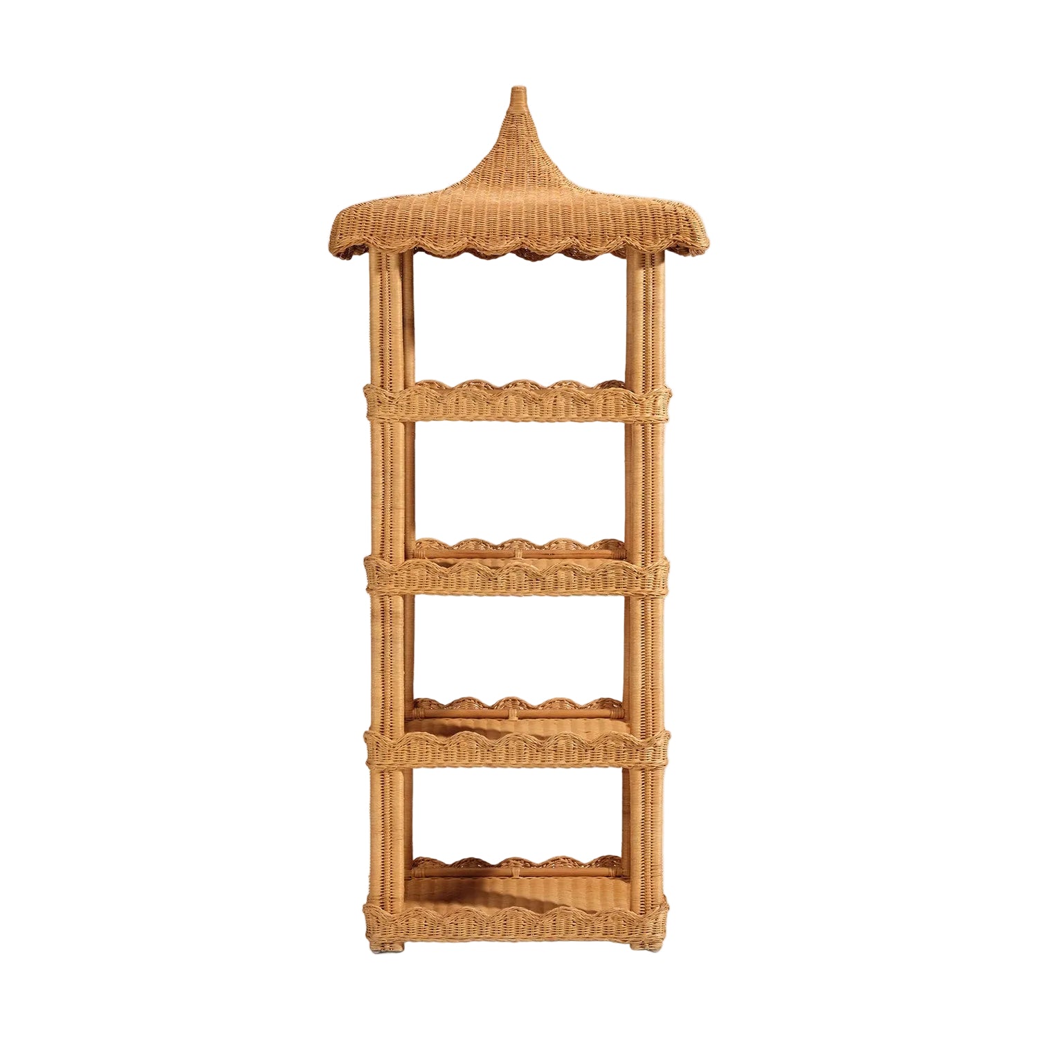 The Georgina Rattan Bookcase by Made Goods features four shelves with scalloped edges and a distinctive pointed, pagoda-style top. Crafted from woven rattan, this standalone piece is perfect for displaying bath essentials or decor, shown here upright against a white background.