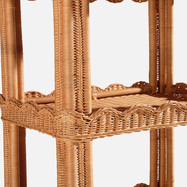 Close-up of the Georgina Rattan Bookcase by Made Goods, showcasing its woven design, multiple shelves, and decorative scalloped edges—ideal for displaying bath essentials or your favorite décor.