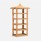 Tall, freestanding Georgina Rattan Bookcase by Made Goods, featuring a pagoda-style crafted roof, four shelves, and decorative scalloped edges in light brown wicker.