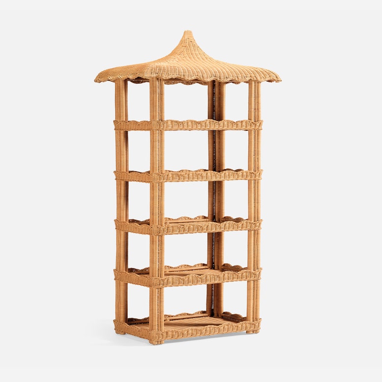 Tall, freestanding Georgina Rattan Bookcase by Made Goods, featuring a pagoda-style crafted roof, four shelves, and decorative scalloped edges in light brown wicker.