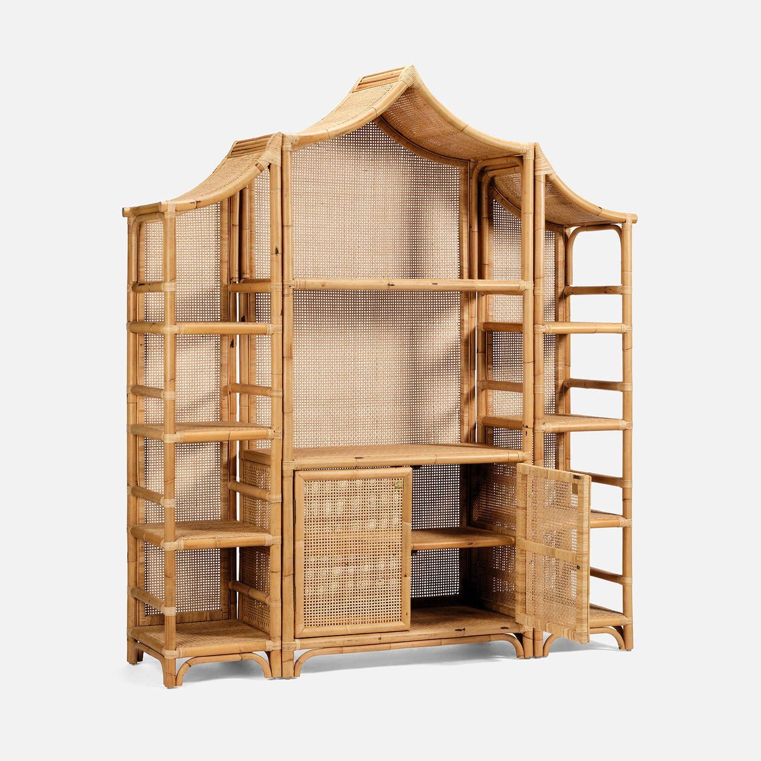 The Lainey 3 Piece Bookcase Set by Made Goods features a large wooden rattan construction with a striking Pagoda-inspired peaked silhouette, multiple open shelves, and two central cabinet doors at the base—making it a stunning statement centerpiece for any space.