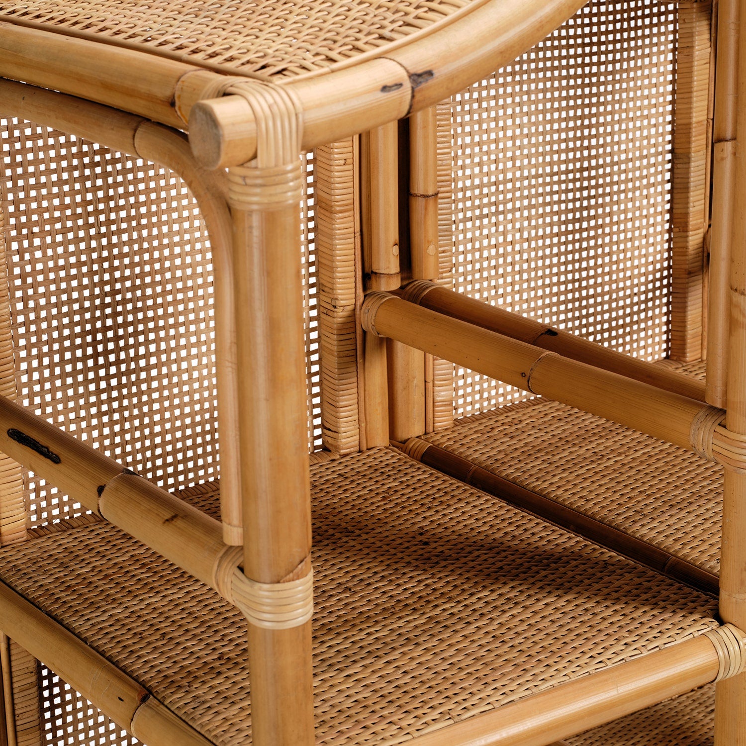 Close-up of the Lainey 3 Piece Bookcase Set by Made Goods, highlighting its rattan and bamboo craftsmanship with woven cane panels, natural wood textures, and artfully joined details—a statement centerpiece for any space.