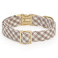 The Mushroom Brown Gingham Dog Collar by The Foggy Dog is displayed on a white background, featuring brown and white gingham fabric and gold metal hardware, including a buckle, clasp, and loop.