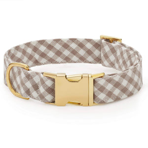 The Mushroom Brown Gingham Dog Collar by The Foggy Dog features a beige and white gingham pattern with a gold metal buckle and D-ring, displayed on a white background.