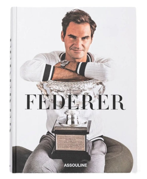 Book cover from Assouline featuring tennis legend Roger Federer holding a large trophy, with the product name "Federer" boldly displayed below.