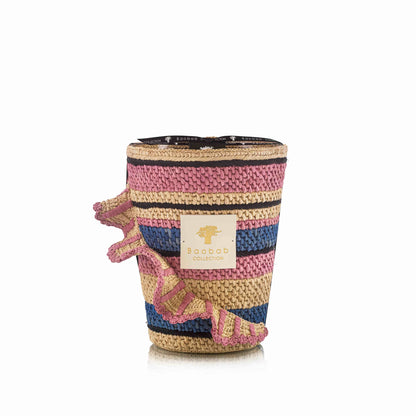 A woven decorative basket, featuring pink, blue, and natural stripes with a frilled side design and labeled tag, pairs perfectly with your Baobab Collection Fety Mandihy Candle.