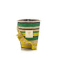 The Baobab Collection Fety Milalao Candle by Baobab is a woven decorative candle holder with green, yellow, and beige stripes plus a yellow ruffle design and front label, infused with calming ylang-ylang notes to bring tranquility to any space.