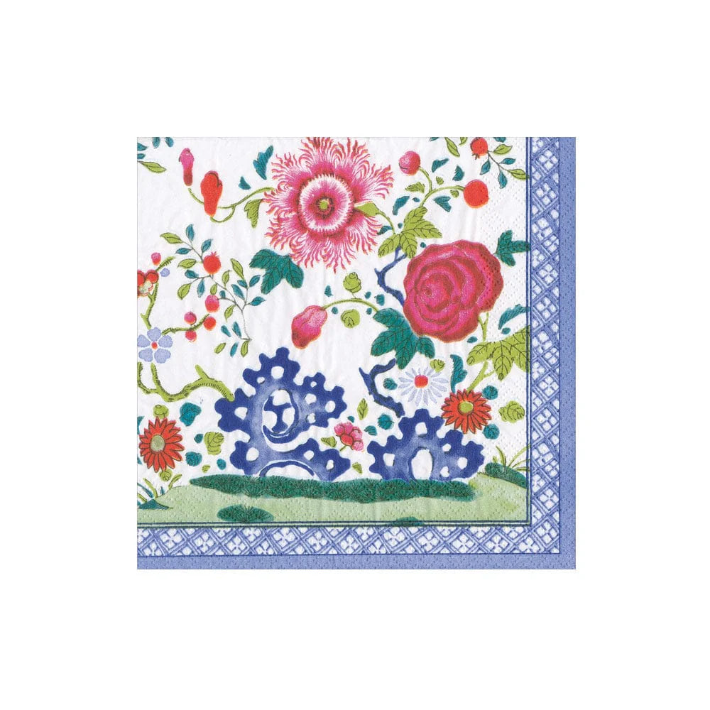 The Caspari Floral Porcelain Collection features beautiful, biodegradable triple-ply napkins with pink and red flowers, green leaves, blue accents, and a blue geometric border—eco-friendly and decorative.