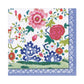 The Caspari Floral Porcelain Collection features elegant, biodegradable triple-ply napkins with blue patterned borders and colorful floral designs on a white background.