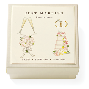 The Karen Adams Just Married Gift Enclosures include 8 cards and 8 envelopes in a cream box with a "JUST MARRIED" lid and hand-glittered art of champagne glasses, rings, bouquet, and cake.
