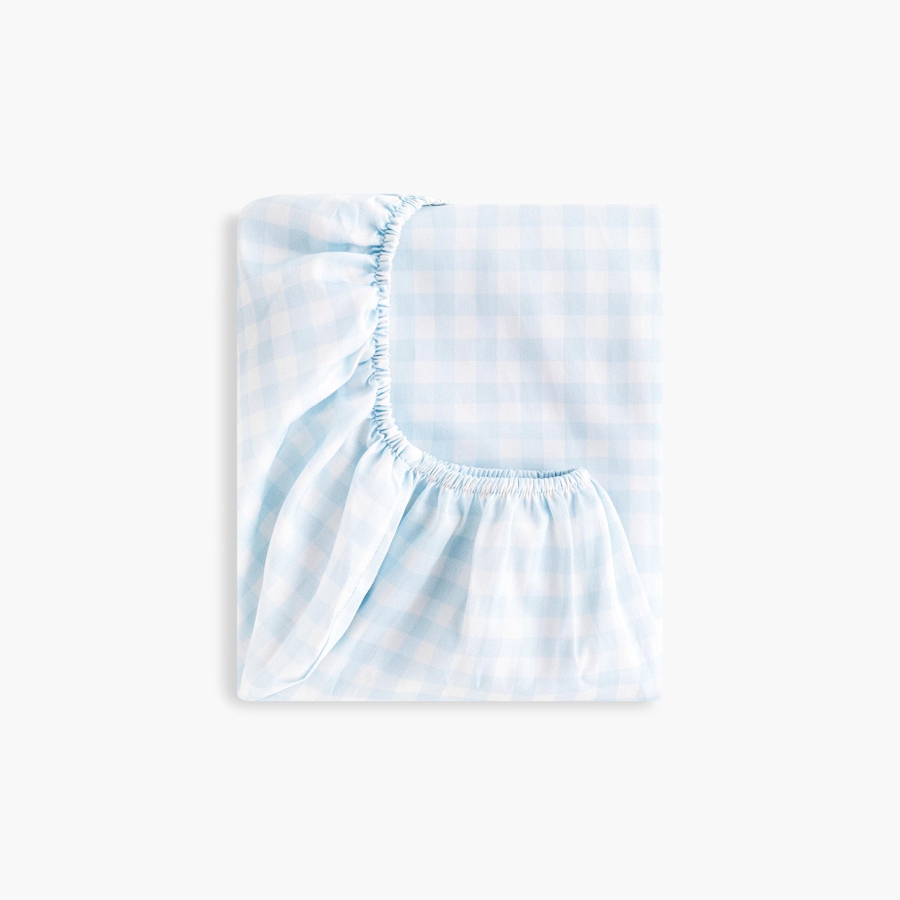 Gooselings Picnic Gingham Blue Crib Sheet: an extra soft, OEKO-TEX certified cotton sateen crib sheet in light blue and white gingham with elastic edges, shown folded against a plain white background.