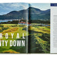 Golfing the British Isles" by Graphic Image features an open book highlighting the Royal County Down, renowned among top courses, with a stunning coastal landscape on the left and descriptive text on the right.
