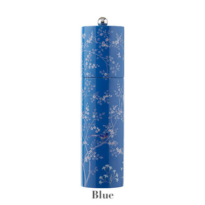 A blue floral Chinoiserie Salt and Pepper Mill from Addison Ross sits on a rubber wood base, with a small round silver knob on top. The word "Blue" appears beneath the container.