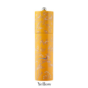 Addison Ross Chinoiserie Salt and Pepper Mill Collection: Tall, yellow cylindrical mill with white floral and bird design, round silver knob, and ceramic grinder. "Yellow" is written underneath.