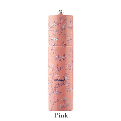 The Addison Ross Chinoiserie Salt and Pepper Mill Collection features a pink cylindrical rubber wood mill, adorned with delicate floral and bird motifs in Chinoiserie style, labeled "Pink" at the base.