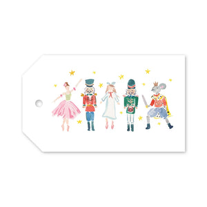 Nutcracker Dreams Gift Tags are rectangular festive tags featuring a watercolor illustration of a ballerina, two nutcrackers, a girl in a white dress, and a mouse king surrounded by small yellow stars.